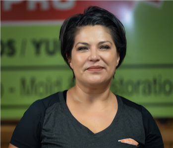 a woman in front of a green background