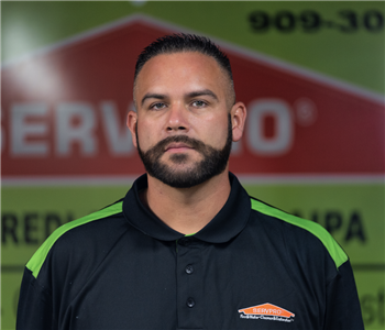 a guy in front of a green SERVPRO background