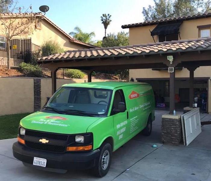 SERVPRO van parked outside home.