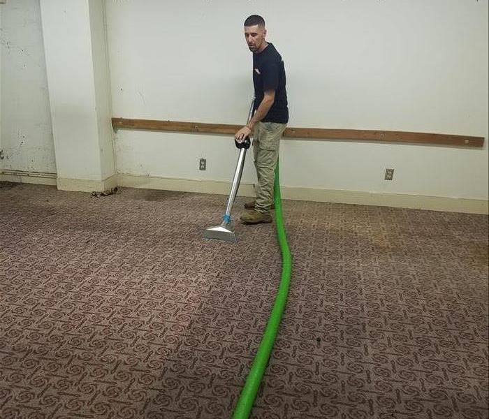 SERVPRO team member extracting water.