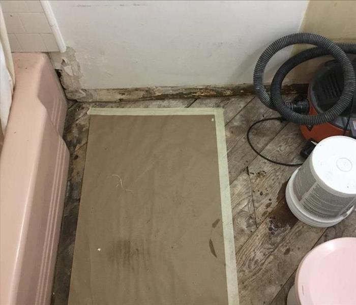 Bathroom with bare wood floors exposed.