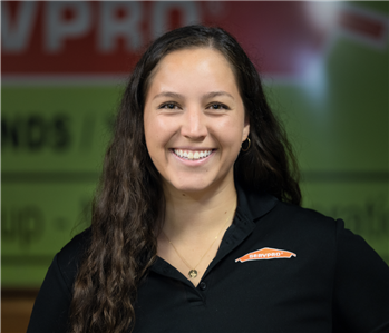 A lady in front of a green SERVPRO background